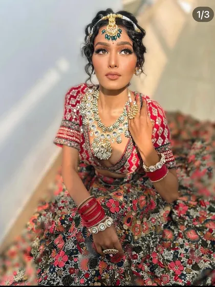 Another angle of the floral lehenga, showing the curly hair styling and the statement jewellery.