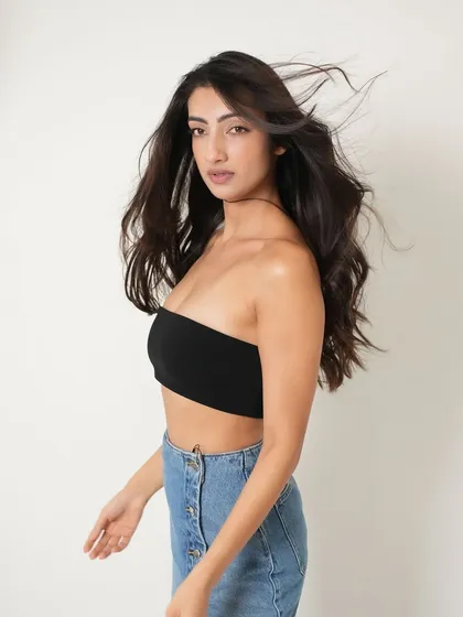 A more casual and modern look from the same shoot. Here, the makeup is stripped back to a fresh, radiant base with a natural lip, showing versatility. The wind-blown hair adds a sense of freedom and energy.