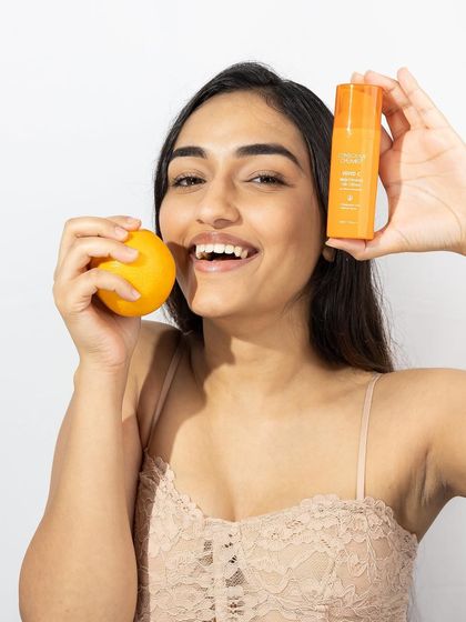 Fun and full of life! This model shot connects the product to its Vitamin C ingredient with a playful pose, creating an image that is both informative and bursting with personality.