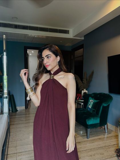 A simple and elegant maroon halter-neck maxi dress for Rakhi. This is a great example of a fusion look that’s comfortable yet festive for a family gathering.