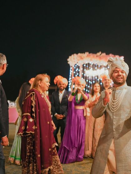 The groom dances with his family during the baraat, a moment of pure celebration.