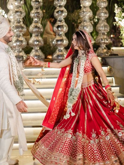 The bride leads the groom in a dance, a beautiful, candid shot from their wedding day that radiates pure happiness.