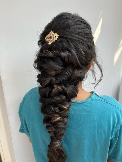 A voluminous, textured fishtail braid. This is a modern and stylish option for a bride or bridesmaid who wants something different from a traditional braid.
