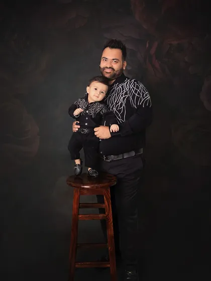 A proud father and his one-year-old son. This portrait captures the special bond between them, a memory to be treasured for a lifetime.