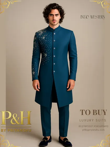 A peacock blue Indo-Western suit designed for modern royalty. The asymmetrical spray of crystal-like hand-embroidery on the shoulder and sleeve adds a celestial, avant-garde touch.