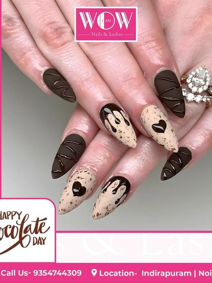 A sweet and decadent design perfect for celebrating. This look features a matte chocolate brown base with 3D drips and a cookie-speckled accent nail.