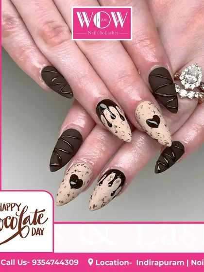 A sweet and decadent design perfect for celebrating. This look features a matte chocolate brown base with 3D drips and a cookie-speckled accent nail.