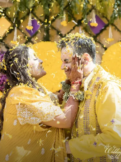 A beautiful, candid moment of the bride playfully applying Haldi to the groom, capturing the love and laughter that fills these ceremonies.
