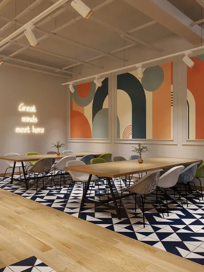 "Great minds meet here." This collaborative seating area uses bold geometric floor tiles and large-scale abstract art to create an inspiring environment for teamwork and brainstorming.