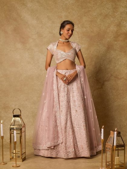 A pastel pink lehenga offers a soft, romantic option for a bride. This piece by Masumi Mewawalla features delicate embellishments and a flowing silhouette, perfect for a daytime wedding or an engagement ceremony where the mood is light and celebratory.