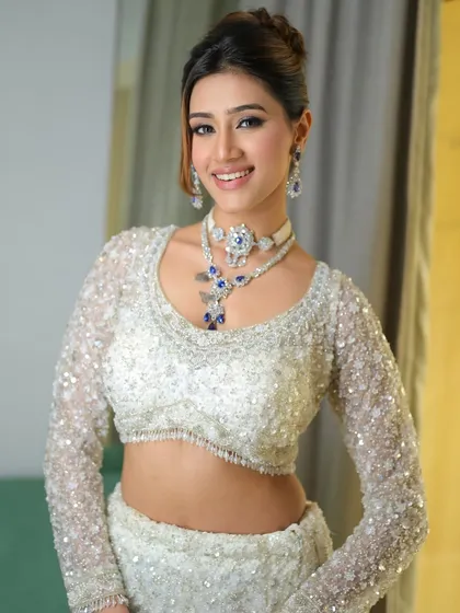 She looks absolutely radiant and ready for her event. The bold makeup is balanced by a classic updo, creating a look that is both modern and timeless.