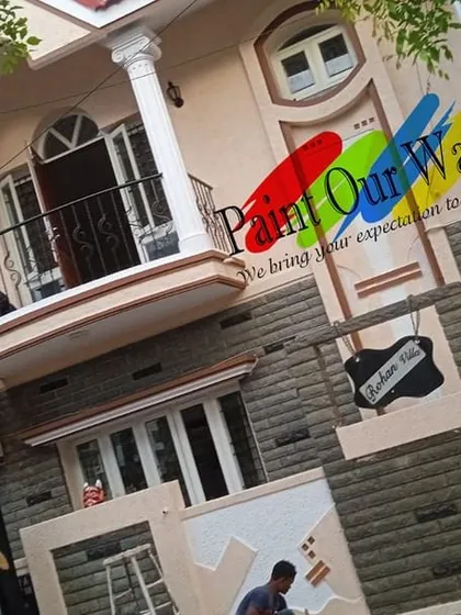 Our team is equipped to handle large, multi-story homes. This shot shows our painters at work, ensuring consistent color and quality across the entire exterior surface.