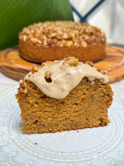 A perfect slice of our seasonal carrot cake, featuring winter spices like cinnamon and nutmeg, and topped with cream cheese frosting and walnuts.