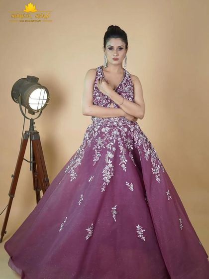 A full-length shot of the magenta gown, showcasing its flowing skirt and the beautiful way the silver embroidery cascades down the fabric.