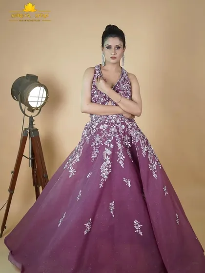 A full-length shot of the magenta gown, showcasing its flowing skirt and the beautiful way the silver embroidery cascades down the fabric.