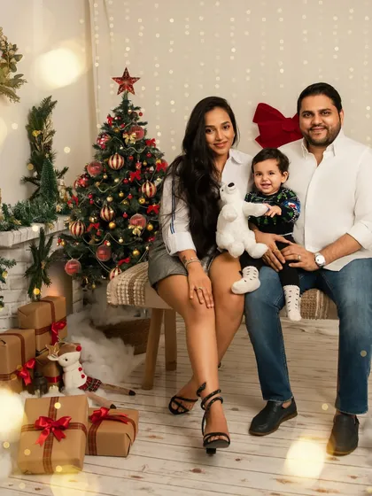 A beautiful family portrait from our Christmas mini sessions. The warm lights and festive decor create a cozy and joyful atmosphere perfect for capturing holiday memories.