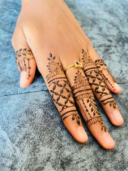 A beautiful set of detailed finger designs, combining lines, nets, and leafy patterns.