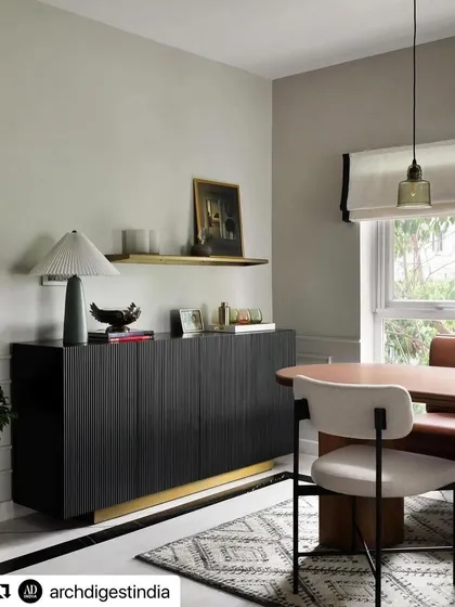 Our black fluted sideboard with a brass base, featured in an Architectural Digest Small Spaces article on a project by Weespaces. The sideboard provides texture and sophisticated storage.
