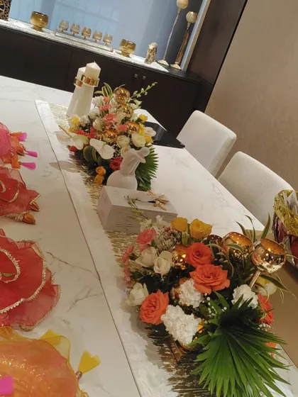A beautifully arranged sit-down dinner table with a floral runner, perfect for a baby shower or intimate celebration.