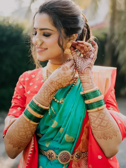 A candid moment of the bride getting ready. The makeup is designed to look beautiful from every angle, highlighting her best features.