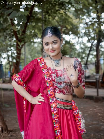 A confident pose showing the model's personality. This shot highlights the traditional tattoo on her hand and the beautiful craftsmanship of her ethnic attire.