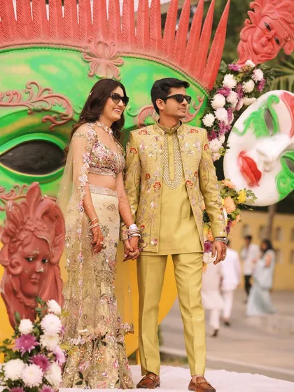 See my custom creation in action. This vibrant lime-green Jodhpuri suit, featuring delicate floral embroidery, was designed for a festive Mehendi ceremony, perfectly capturing the joyous and colorful spirit of the event.