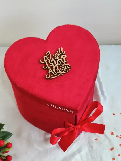 The elegant red velvet heart-shaped box, with an "I will love you always" message on top.