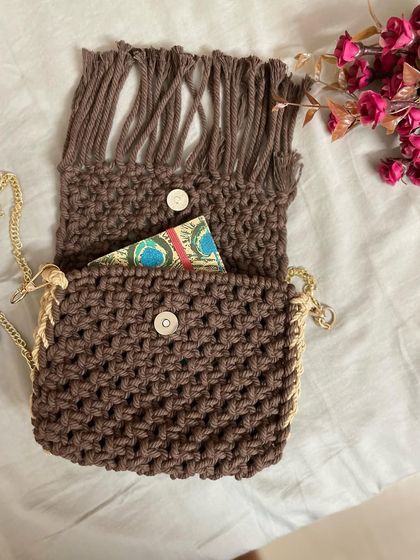 Let's look inside! The bag has a simple button closure and is unlined to keep it soft and flexible, showing off the natural beauty of the cotton knots.