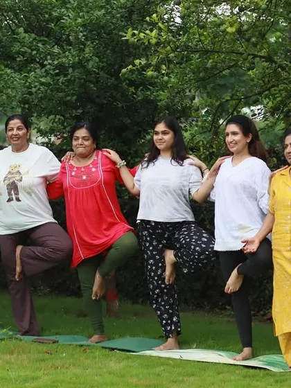 A fun moment practicing tree pose together during an outdoor yoga session. There is so much strength and laughter when we support each other, both on and off the mat.