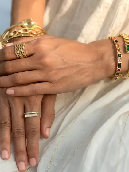 Elegance in every detail. This look features my emerald loop and multi-colored cuff bangles, paired with simple gold rings for a sophisticated vibe.