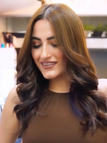 A close-up of the client's happy expression. A great hair transformation is about more than just looks; it's about how it makes you feel.