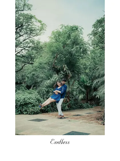 A fun, spontaneous lift captured in a park setting. These joyful, unscripted moments often become the couple's favorite photos.