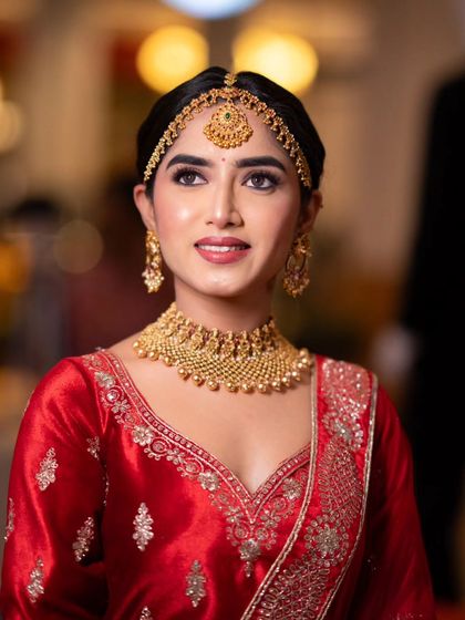 A smiling portrait from the masterclass, showing a classic North Indian bridal look.