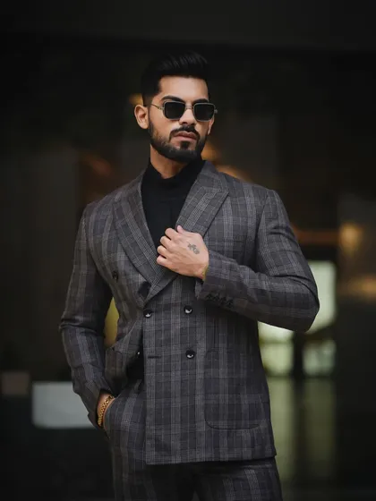 A classic, powerful portrait for a men's fashion portfolio. The focus here is on sharp tailoring and a confident stance, using controlled lighting to create a look that is both timeless and modern.