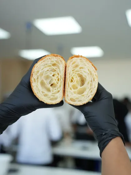 This is the anatomy of a perfect croissant. That beautiful honeycomb structure is a result of mastering the art of lamination, a technique we teach with precision. It's about creating those buttery, flaky layers that define world-class viennoiserie.