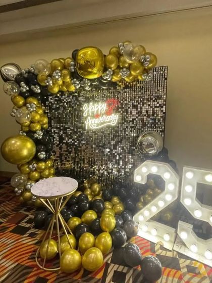 A close-up of the 25th-anniversary decor, showing the details of the balloon arrangement and sequin wall.