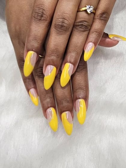 Bright, bold, and unapologetic. These long, almond-shaped nails feature a vibrant yellow with a unique clear, negative space design. It's a sunny and confident look.