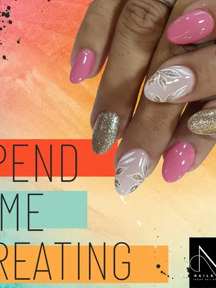 This elegant design combines a soft pink base with gold glitter and white leaf-patterned accent nails. It's a perfect example of a sophisticated yet detailed manicure.