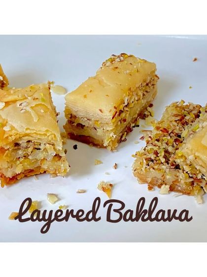 My layered Baklava is a labour of love. I brush each sheet of filo pastry with butter and layer it with a mixture of chopped nuts and spices, then bake it and soak it in a light honey syrup.
