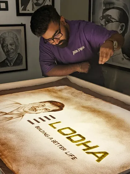 Revealing the Lodha logo and founder's portrait in sand. This is how I tell a brand's story.