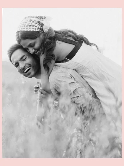 A playful piggyback ride through the tall grass. This black and white photo, with its soft focus, feels nostalgic and sweet, like a cherished memory from a perfect day.
