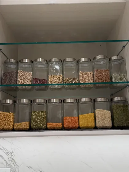 A close-up of a perfectly organized dal and pulse collection. Using transparent jars with airtight lids ensures you can see exactly what you have while keeping everything fresh.