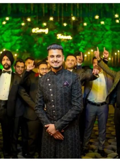 Our client graces his wedding occasion in a mesmerizing fusion of tradition and modernity, a bespoke black sherwani with ornate motifs.