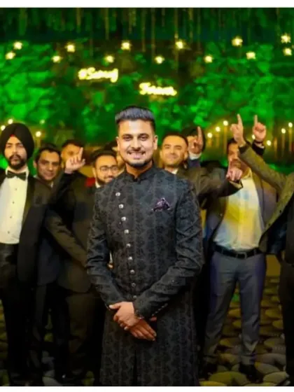Our client graces his wedding occasion in a mesmerizing fusion of tradition and modernity, a bespoke black sherwani with ornate motifs.