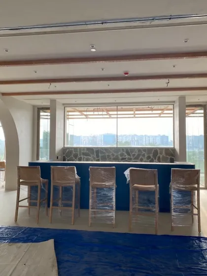 A work-in-progress view of the Godrej Woods Clubhouse in Gurugram. This image shows the bar area taking shape, with the fundamental architectural elements and material palette being established.