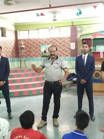 Mr. Ramesh Bansal Ji demonstrating a technique to students and instructors at a school workshop. Leadership is about actively teaching and sharing knowledge.