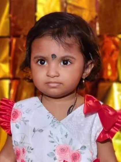 A close-up of this sweet girl in a floral print dress with red satin flutter sleeves. It's a lovely combination of comfort and special details.