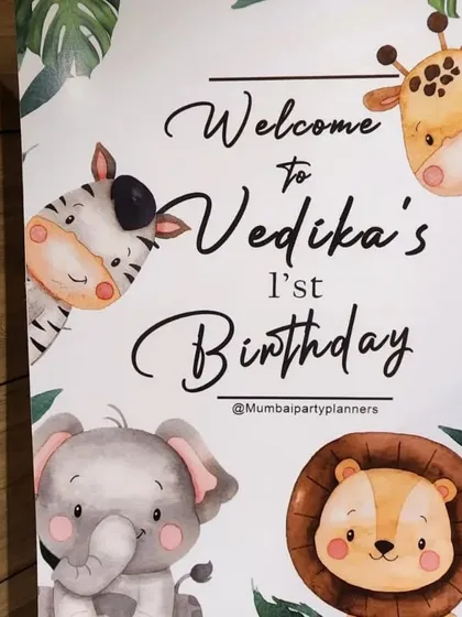 A personalized welcome sign featuring cartoon safari animals greets guests at the entrance, perfectly matching the party's theme.