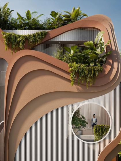 A close-up of the facade, where a circular window offers a glimpse into the interior, creating a connection between the sculptural exterior and the living spaces within.