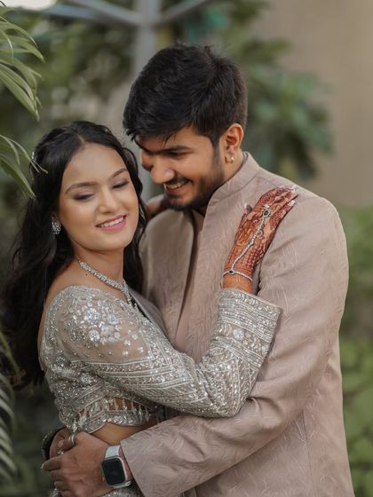 An adorable candid shot of the couple. You can see the bride's glowing skin and the subtle shimmer on her eyes, a perfect example of an elegant engagement look.